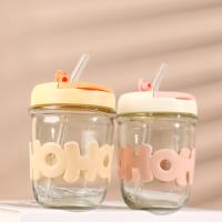 A cup with a straw made of letters