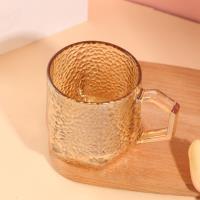 A hexagonal hammer-patterned cup with an amber color
