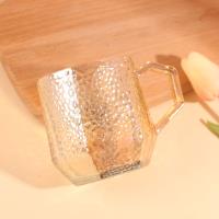 A hexagonal hammer-patterned cup with an amber color