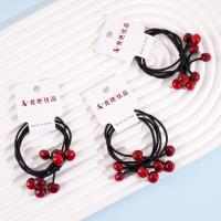 2 red cherry-shaped rubber bands with a string loop at each end