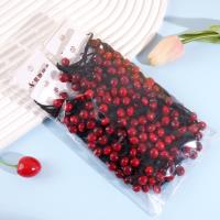 2 red cherry-shaped rubber bands with a string loop at each end