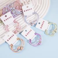 2 colorful balls with golden bead head rope and rubber bands