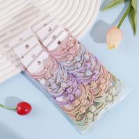 2 colorful balls with golden bead head rope and rubber bands