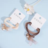 2 crystal ribbons combined with a headband and a rubber band