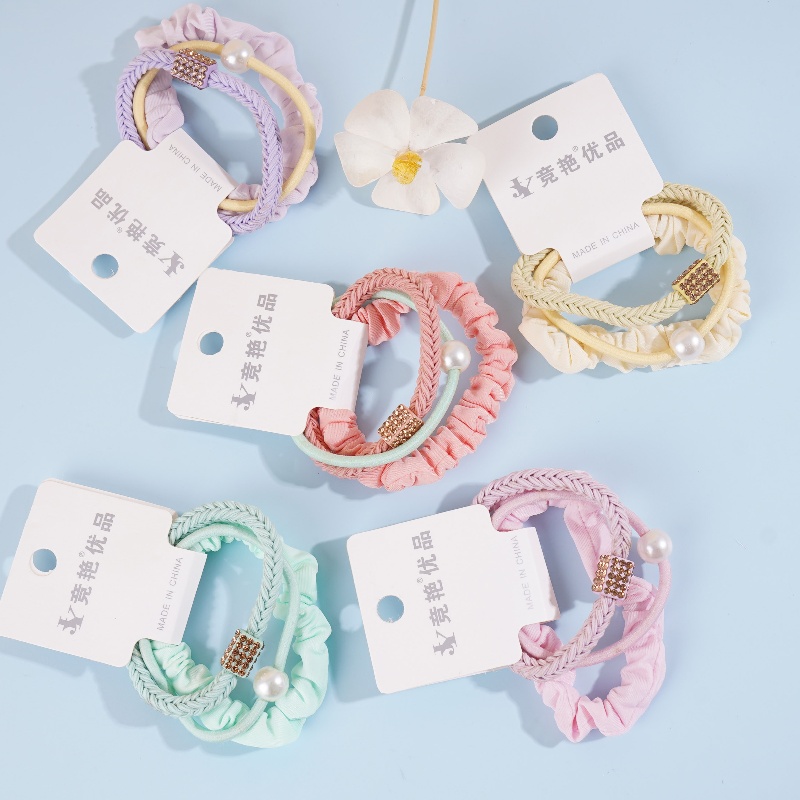 A set of three square braids with rectangular diamonds, combined with colorful headbands and rubber bands