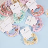 A set of three square braids with rectangular diamonds, combined with colorful headbands and rubber bands