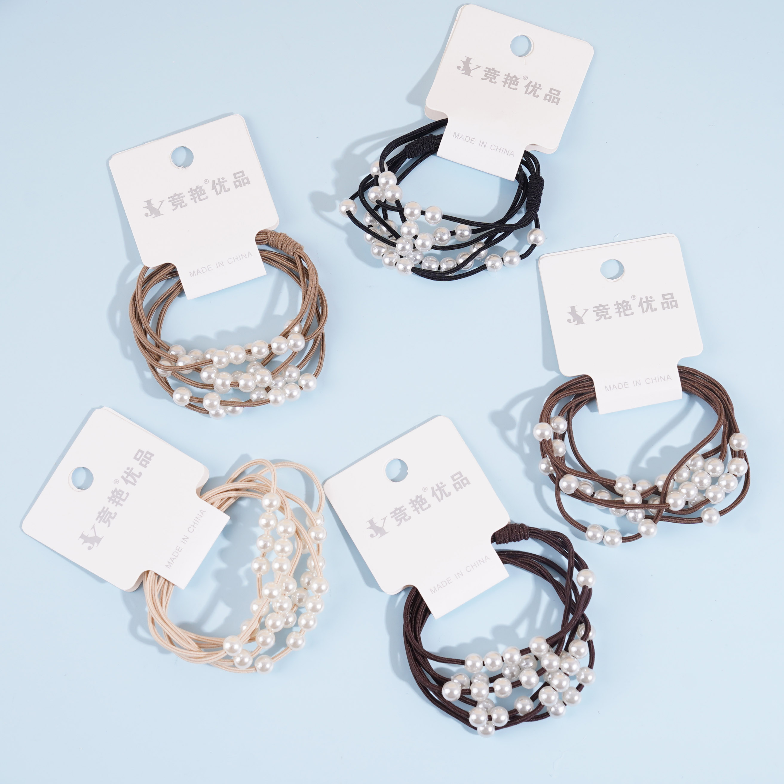 2 large pearl-headed rubber bands with a rose knot design