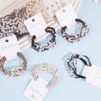 2 large pearl-headed rubber bands with a rose knot design