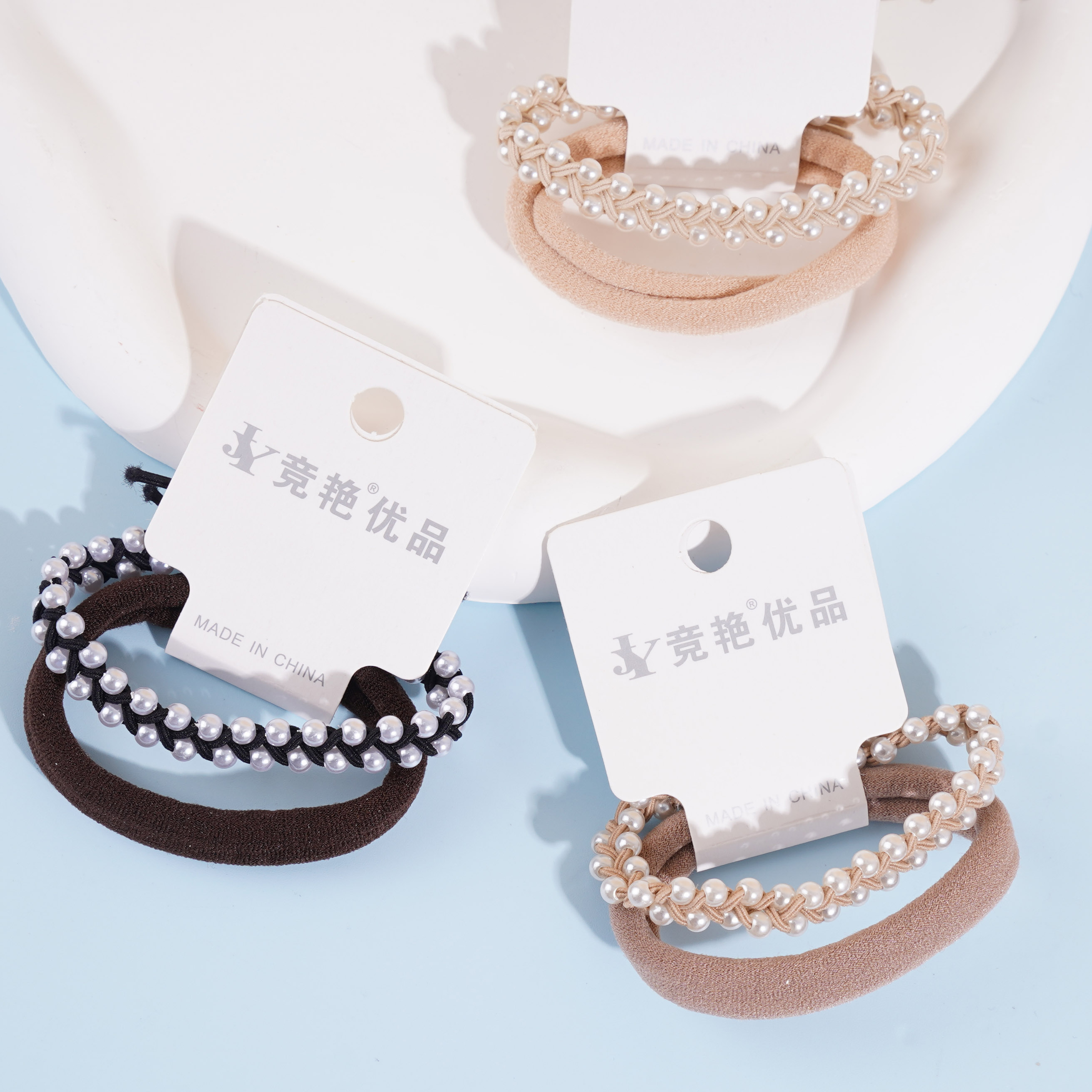 2 braids with a double row of pearls combined with a headband and a rubber band