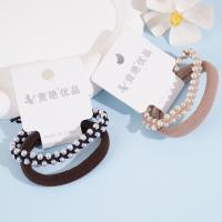 سوار رأس مكون من 2 ضفائر مزينة بأحجار اللآلئ المتراصة، مع شريط مطاطي لتثبيته.