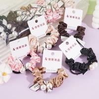 2 pieces of heat-pressed diamond-embroidered ribbons with pearls, small intestine-shaped ropes, and rubber bands