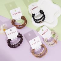 2 bean-shaped leather bracelets with a knotted design and diamond-shaped beads on the ends, secured with elastic bands
