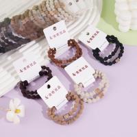 2 bean-shaped leather bracelets with a knotted design and diamond-shaped beads on the ends, secured with elastic bands