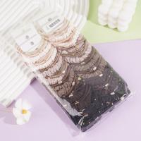 A set of three heart-shaped gold beads, featuring a delicate design, paired with a headband and elastic bands