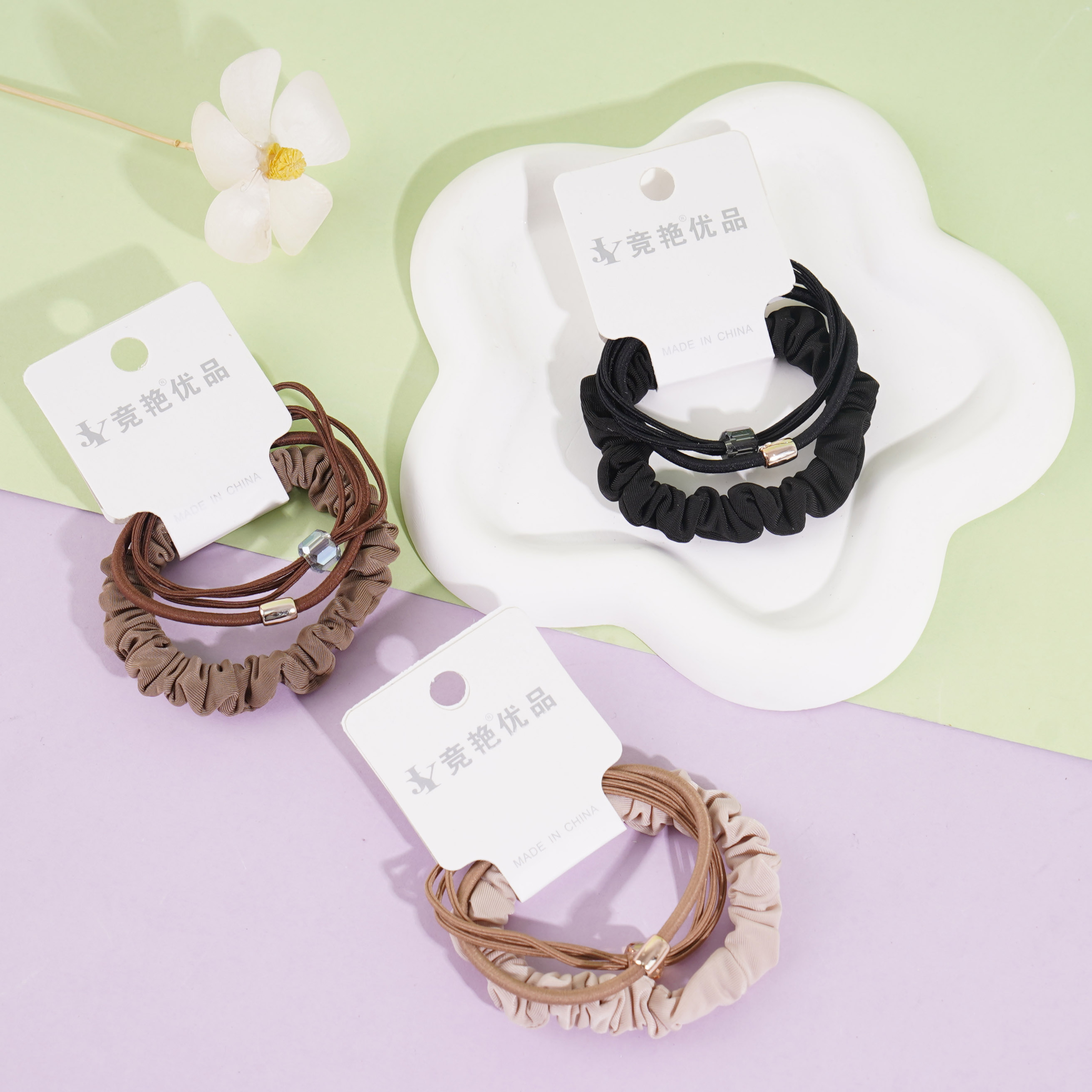 A set of three square diamond-shaped, exquisitely designed headbands and elastic bands