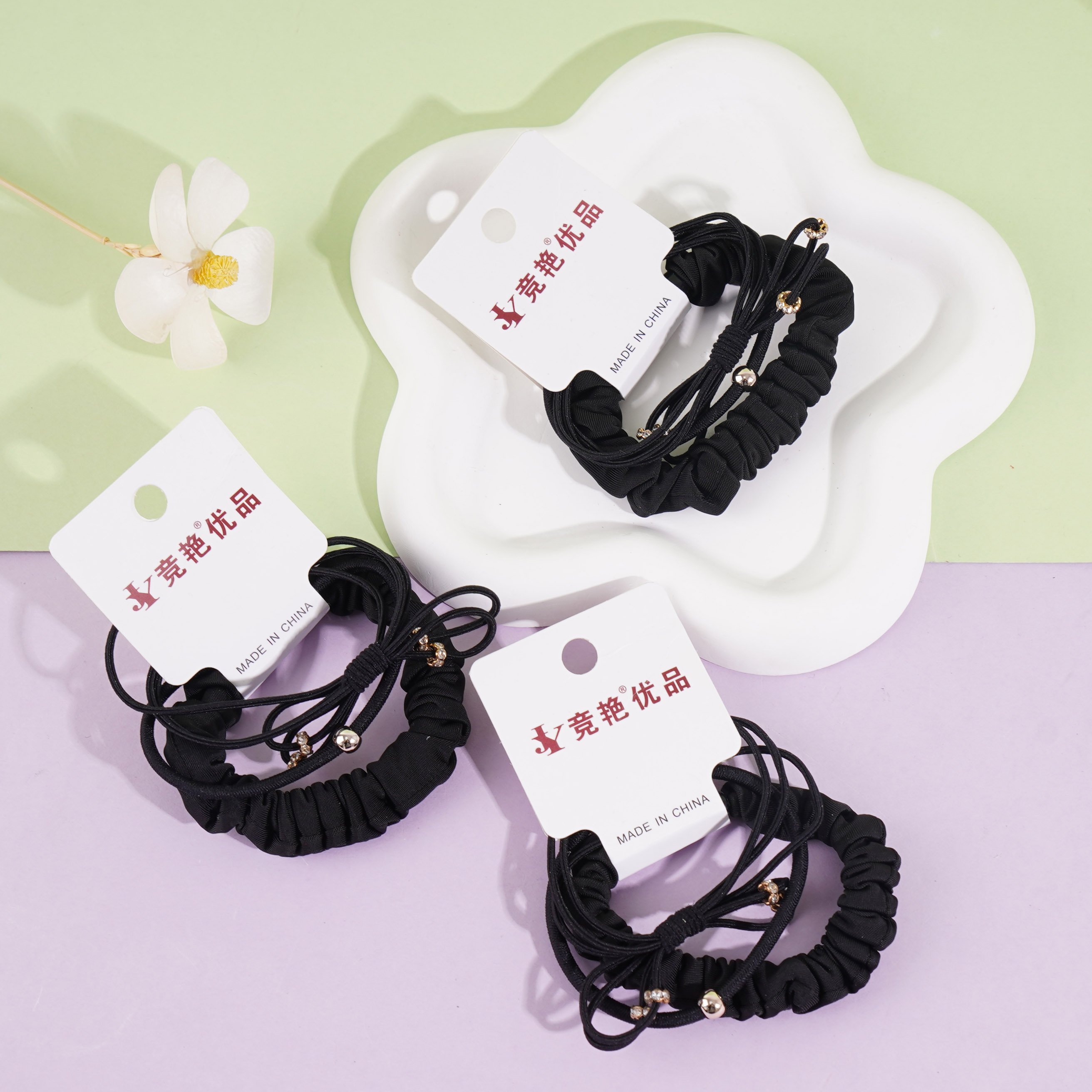 A set of three delicate bow-shaped headbands and elastic bands (black)