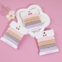 4 colored towel rings in a box