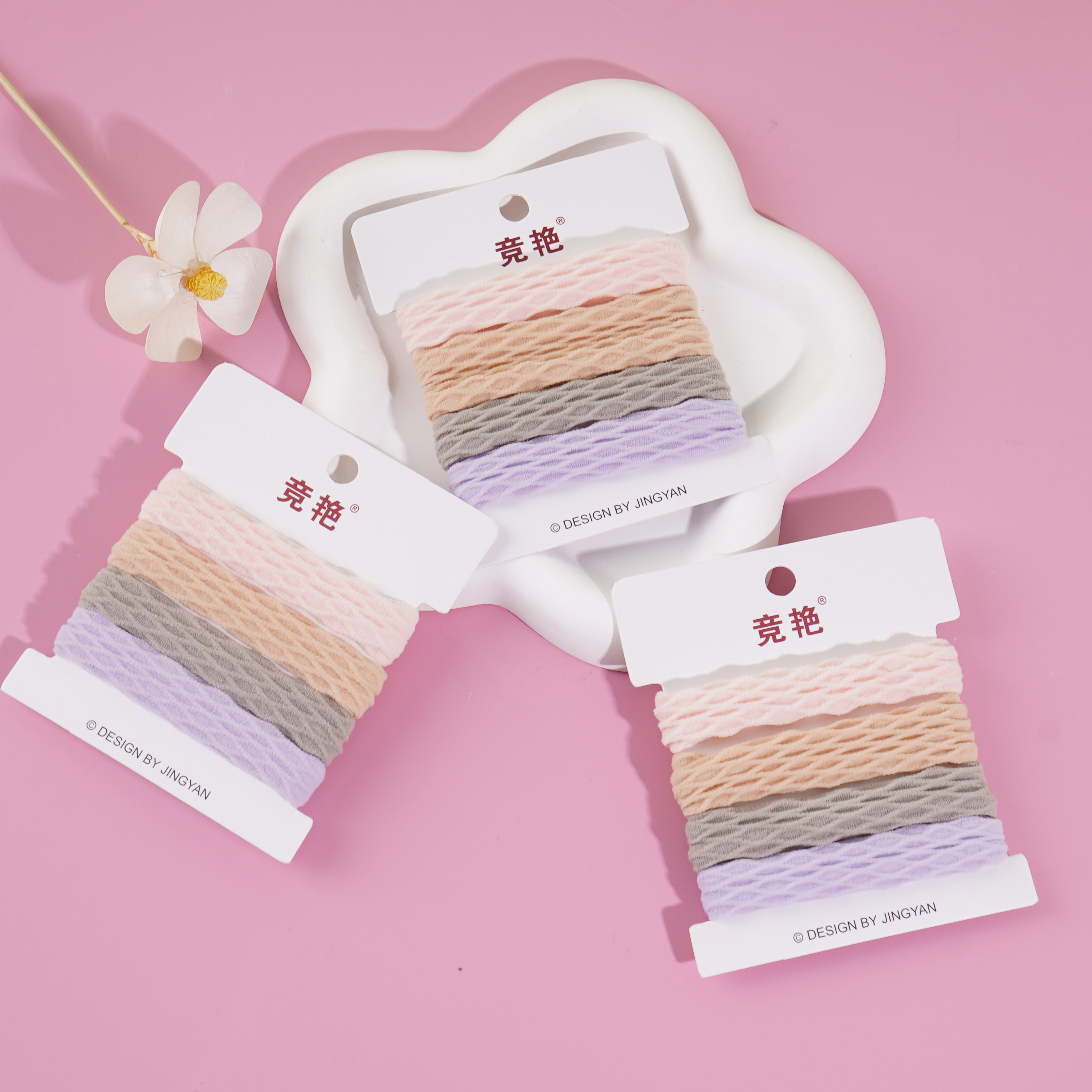 4 colored towel rings in a box