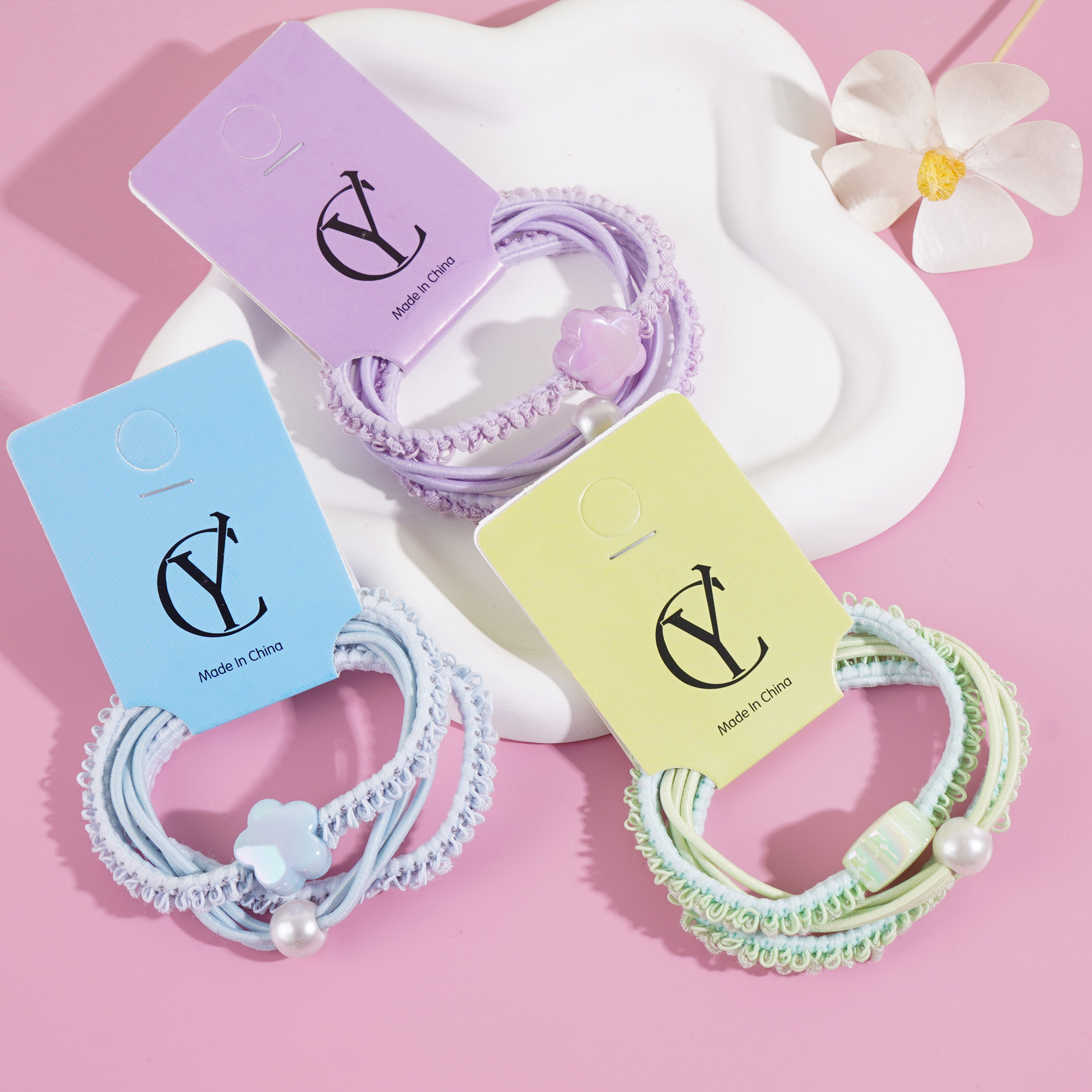 3 colorful flower-shaped headbands with elastic bands