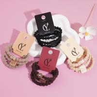 A set of three heart-shaped bear-themed headbands and rubber bands