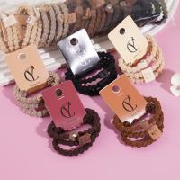 A set of three heart-shaped bear-themed headbands and rubber bands