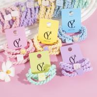 A set of three colorful bear-themed headbands and elastic bands