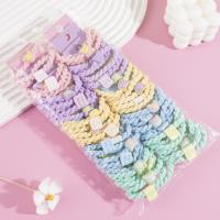 A set of three colorful bear-themed headbands and elastic bands