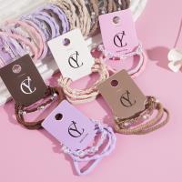 A set of three pearl-strung headbands and elastic bands