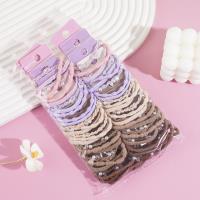 A set of three pearl-strung headbands and elastic bands