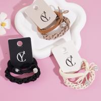 A set of two pearl and diamond bow-shaped headbands with elastic bands