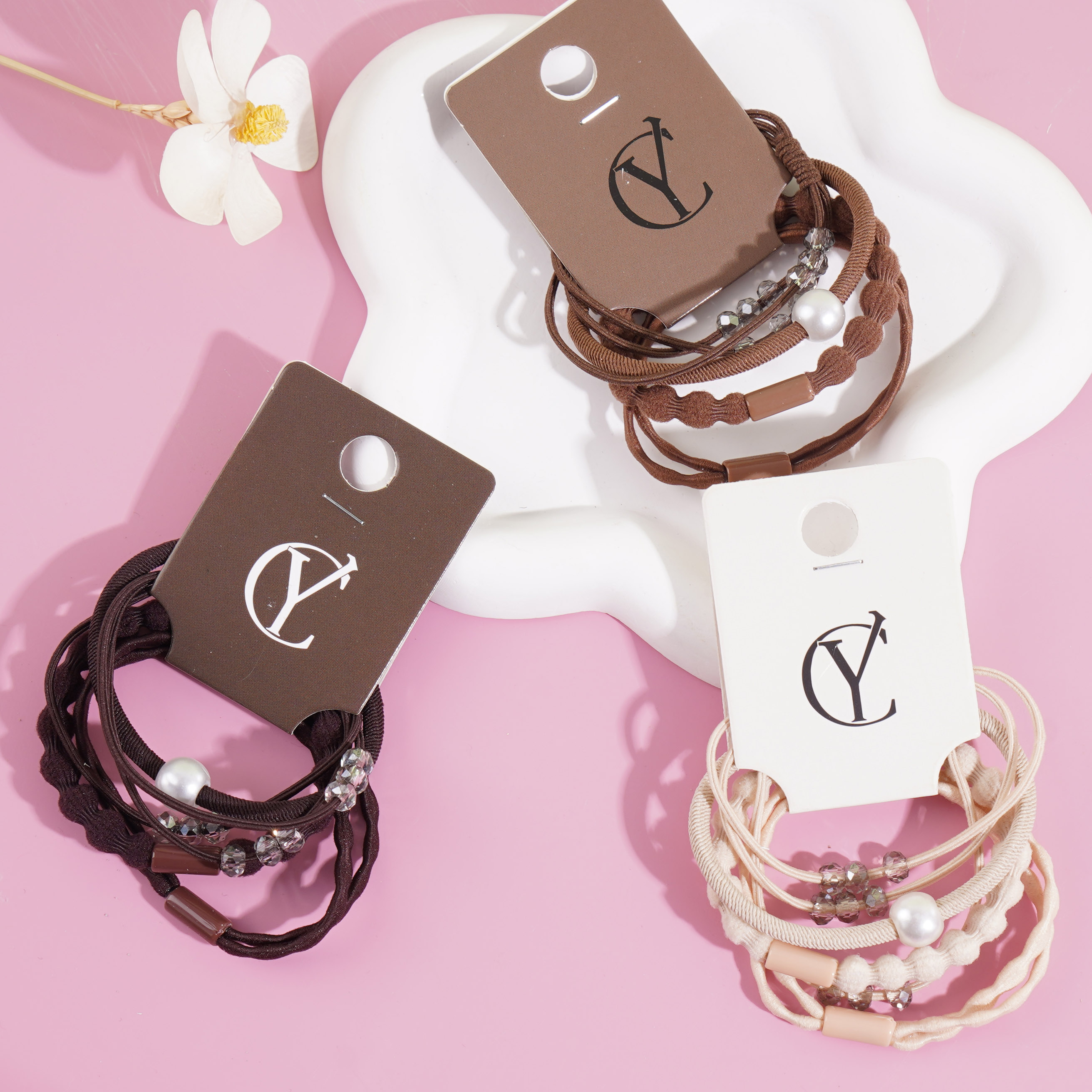 A set of four crystal pearl combination headbands and elastic bands