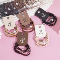 A set of four crystal pearl combination headbands and elastic bands