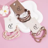 A set of three small pearl headbands with elastic bands