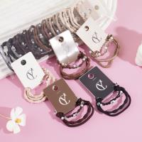 A set of three small pearl headbands with elastic bands