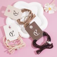 A set of three large pearl bow headbands with elastic bands