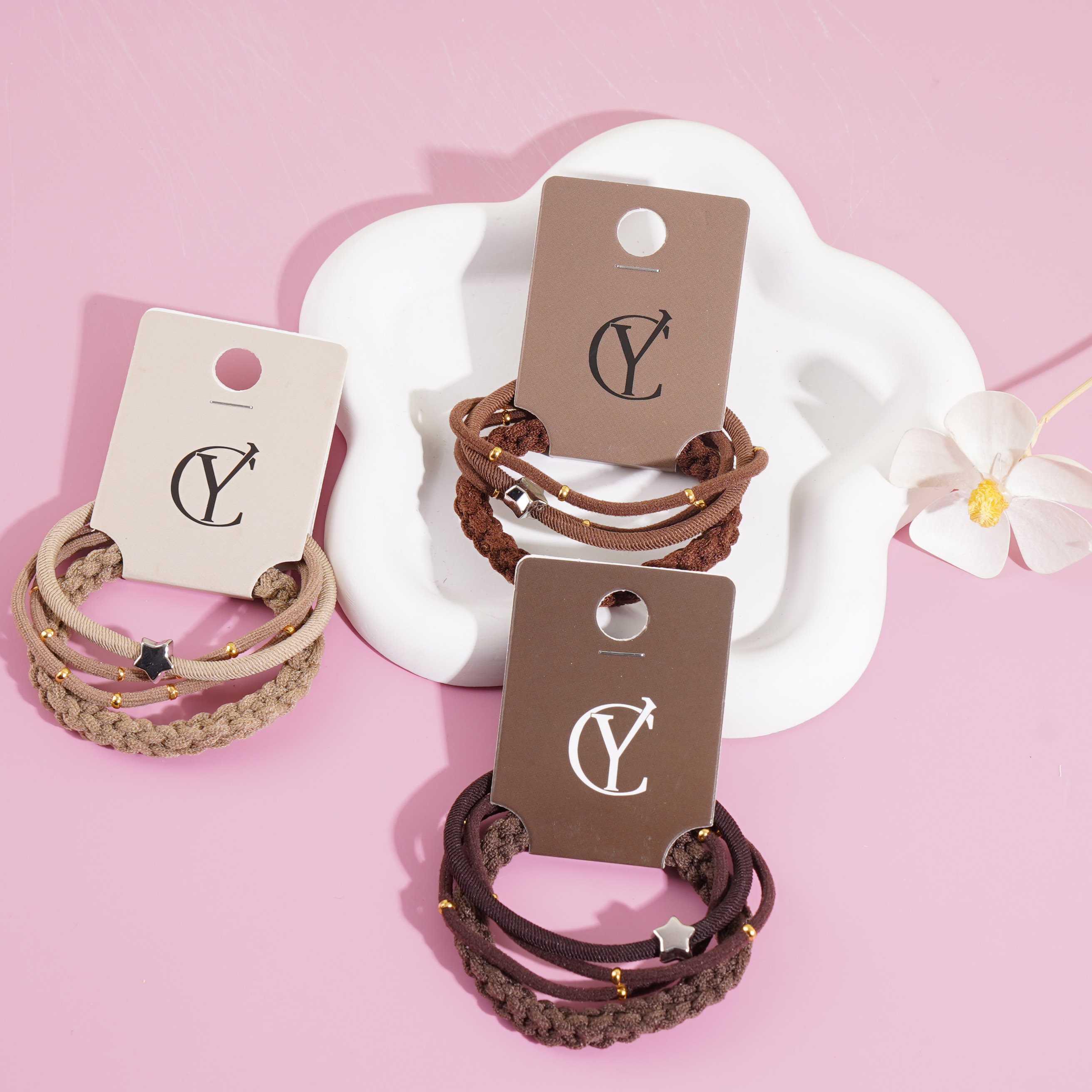 A set of three gold bead star-shaped necklaces, combined with a string of beads and a rubber band as a headband