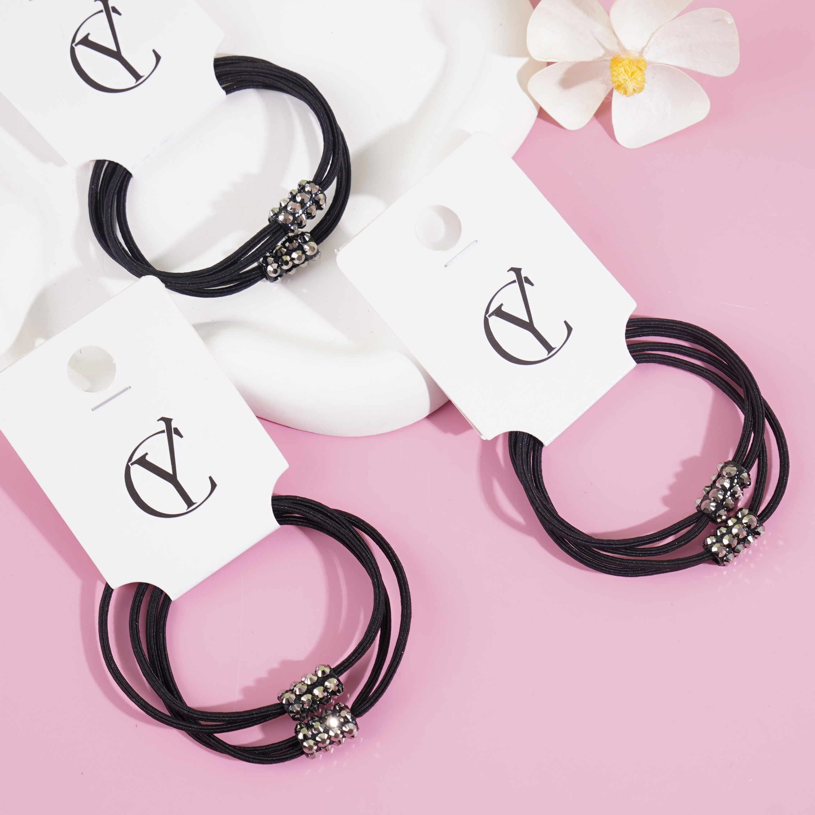 2 black diamond-themed headbands with elastic bands