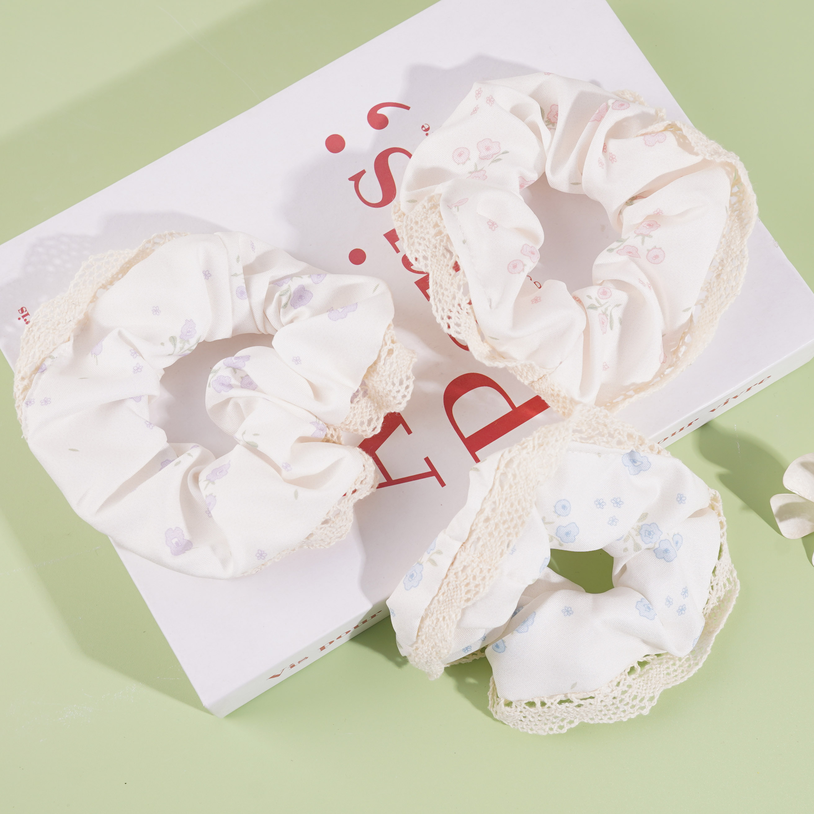 A headband with a floral lace design and a choker-style collar