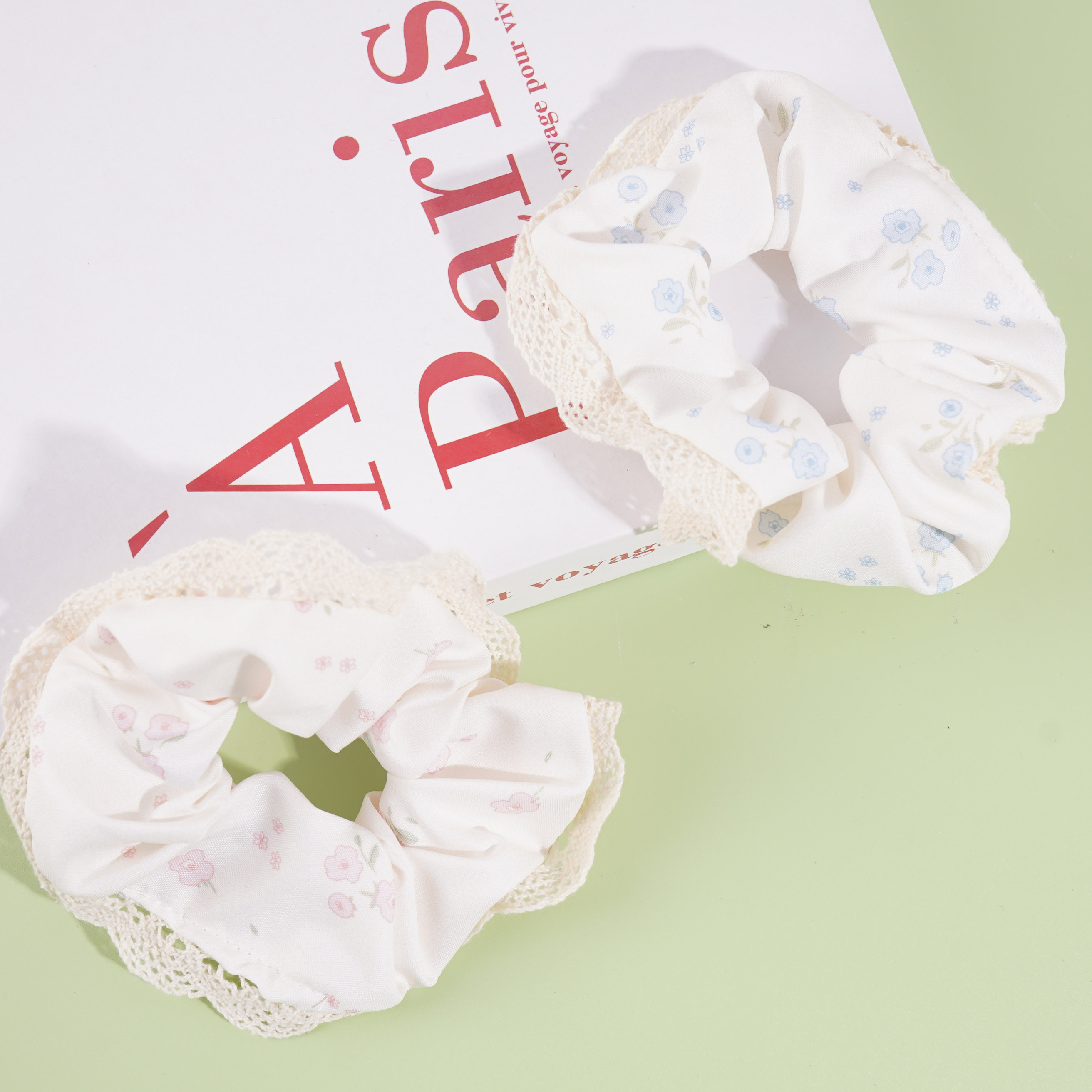 Floral lace headpiece with a hollow-out design and a ribbon-like trim