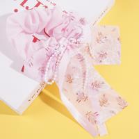 A delicate pearl sausage-shaped ring with a flowing ribbon design