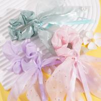 A small diamond pearl intestinal ring pendant with a flowing ribbon design