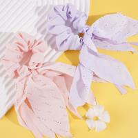 A small diamond pearl intestinal ring pendant with a flowing ribbon design