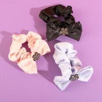 A bow-shaped colonoscopy device with a fluttering ribbon attached to it.