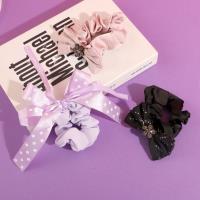 A bow-shaped colonoscopy device with a fluttering ribbon attached to it.