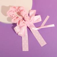 A bow-shaped colonoscopy device with a fluttering ribbon attached to it.