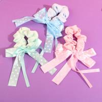 A bow-shaped colonoscopy device with a fluttering ribbon attached to it.