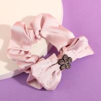 A bow-shaped colonoscopy device with a fluttering ribbon attached to it.