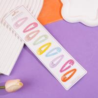 A long strip of cartoon-themed BB-style paperclips with colorful designs