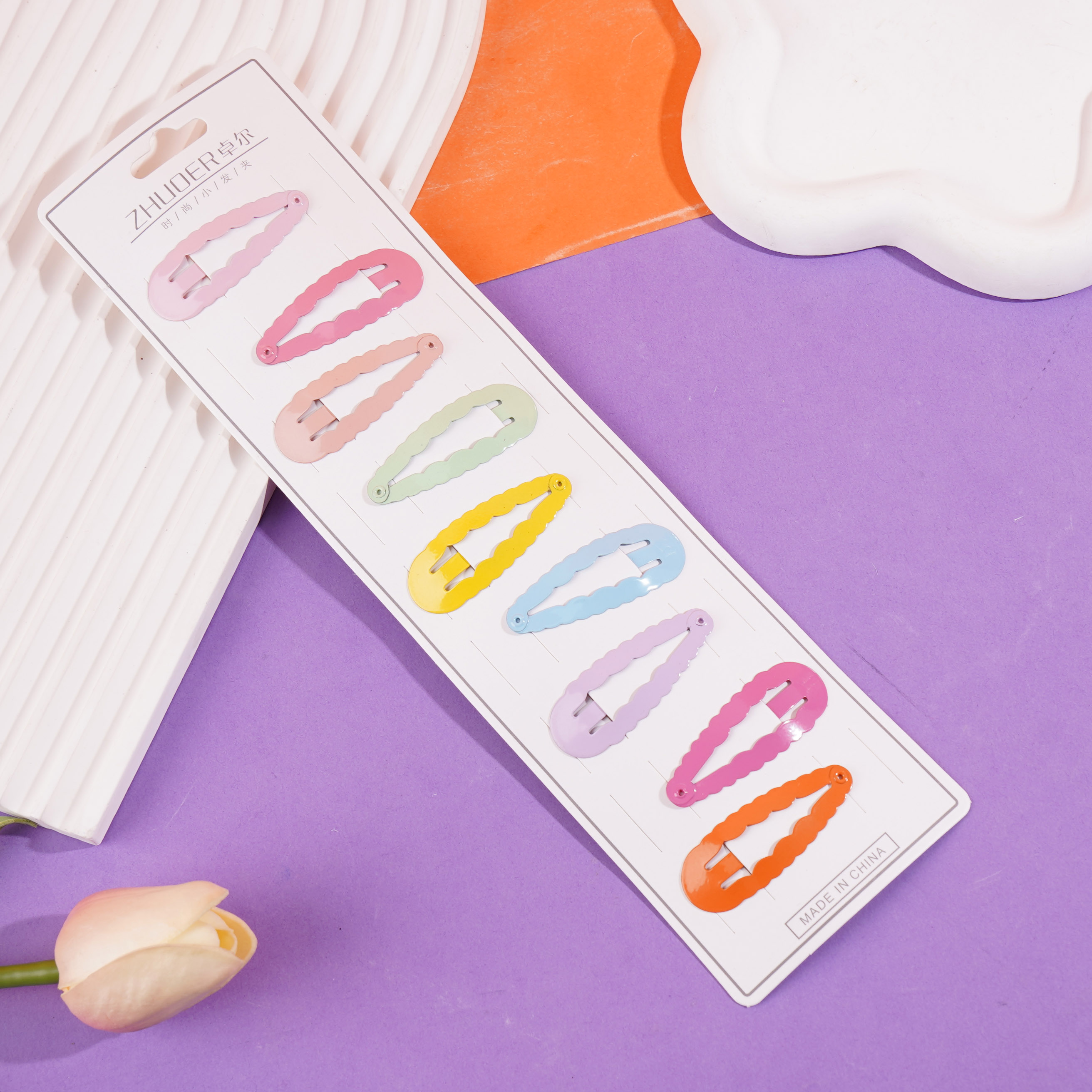 A long strip of cartoon-themed BB-style paperclips with colorful designs