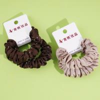 2 pieces of large intestine, marinated with soy sauce, milk coffee sauce, and topped with a rope-like elastic band made from leather